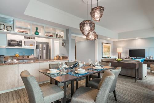 a dining room and living room with a table and chairs at Ascott Makati in Manila