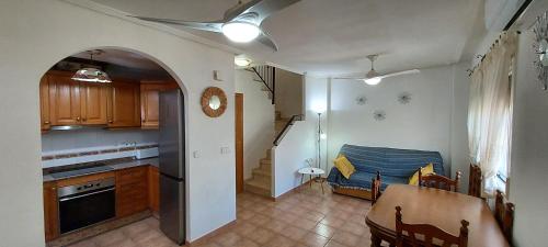 a kitchen and dining room with a table and a dining room at Villa Adelina en Santa Pola in Santa Pola
