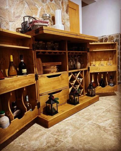 a wooden cabinet filled with lots of wine bottles at The Post Stana de Vale in Stana de Vale
