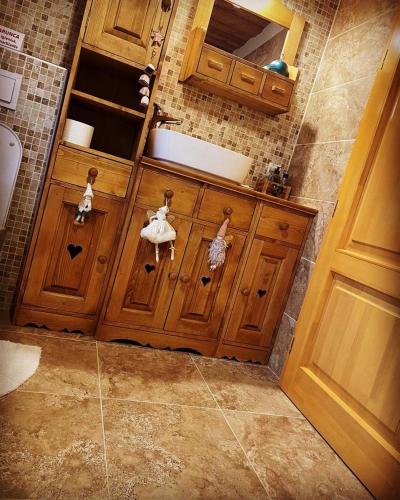 a bathroom with a sink and two dolls on a wooden door at The Post Stana de Vale in Stana de Vale