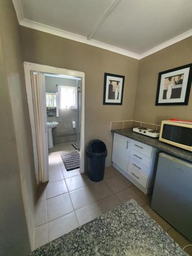 cocina con encimera y microondas en ROCKABILLY RANCH Self-Catering Guest Units en Pietermaritzburg