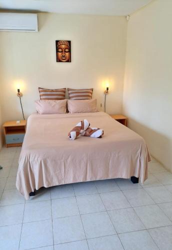 a stuffed animal on a bed in a bedroom at Villa Soleil in Mont Choisy