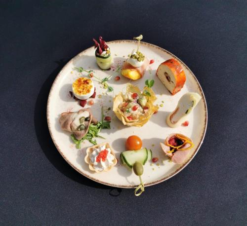 a plate with different types of food on it at Podu' cu Lanturi in Bacău