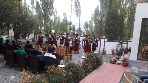 a group of people standing in front of a crowd at Hotel Lhalingkha in Leh
