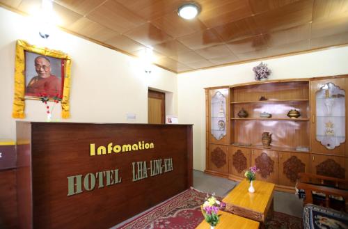 a hotel room with a reception desk and a table at Hotel Lhalingkha in Leh
