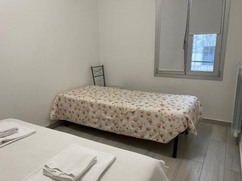a room with a bed and two tables and a window at Apartment Orio Volta in Orio al Serio