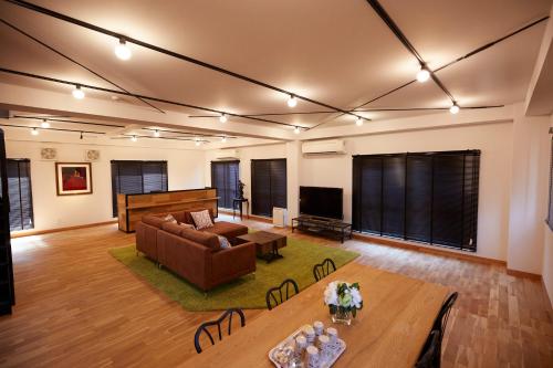 a living room with a couch and a table at HOTALU Universal Vacation - Kan in Osaka