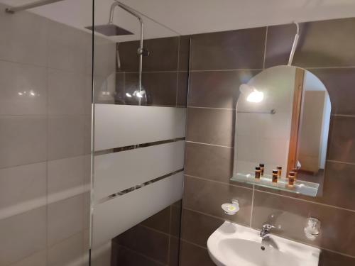 a bathroom with a sink and a mirror at Nikos Apartments in Ormos Panagias