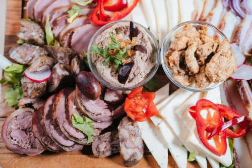 a plate of food with different types of meat and vegetables at Podu' cu Lanturi in Bacău