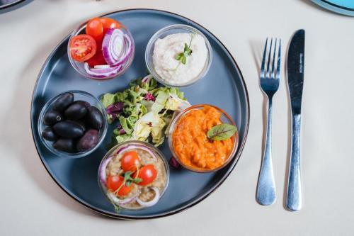 a blue plate with food on a table at Podu' cu Lanturi in Bacău