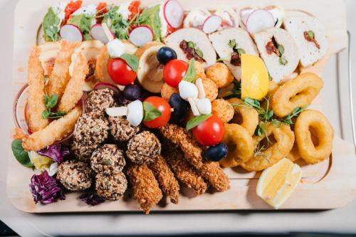 a plate of food with different types of appetizers at Podu' cu Lanturi in Bacău