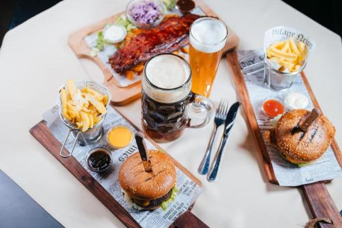 a table with two plates of food and drinks on it at Podu' cu Lanturi in Bacău