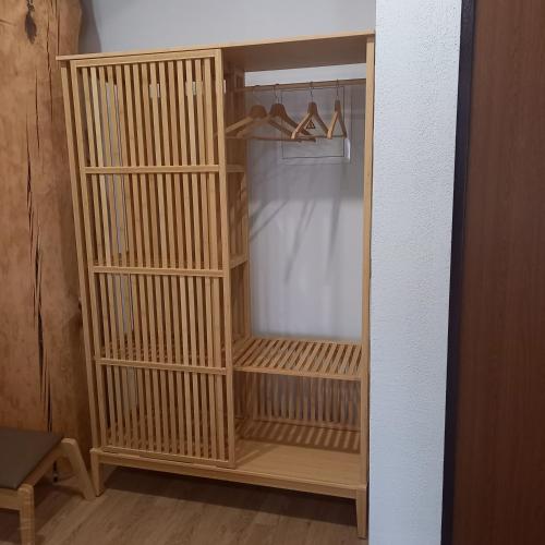 a closet with wooden shelves and shoes in it at S Neries 19 apartamentai su parkingu in Šiauliai