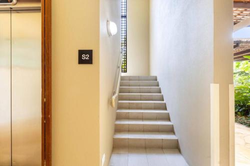 a staircase leading up to a building with a sign on it at Bellflower at Temple - Family Beachside Paradise in Palm Cove