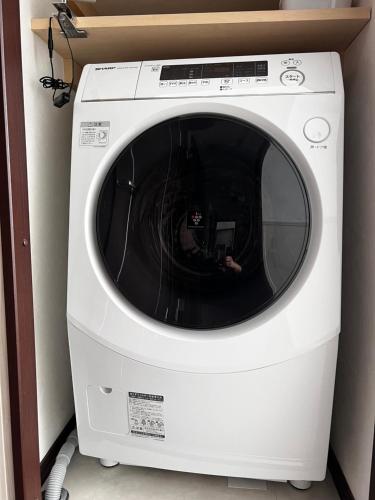 a white washer and dryer in a room at Chalet Fuyuri in Furano