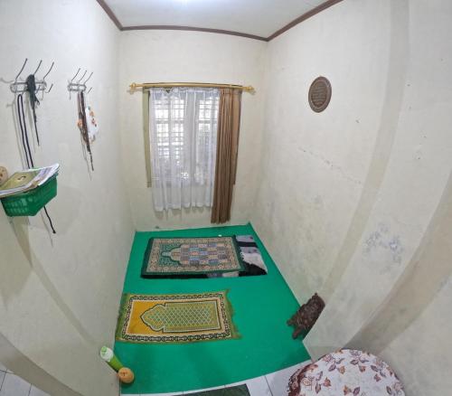 a room with a green table and a window at Omah Tegalrejo Family Only in Jetis