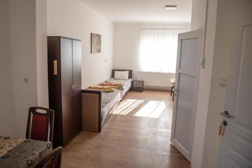 a room with a bedroom with a bed and a window at Apartments Kuca Aleksic in Niš