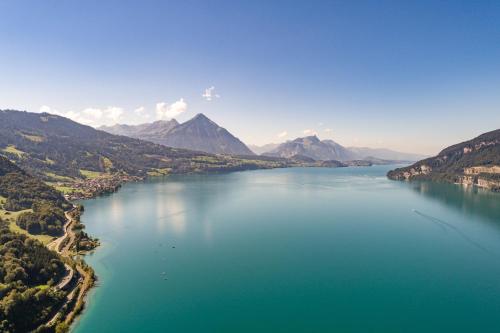 an aerial view of a large body of water with mountains at Bijou du Lac - mit Pool und Privatstrand in Därligen
