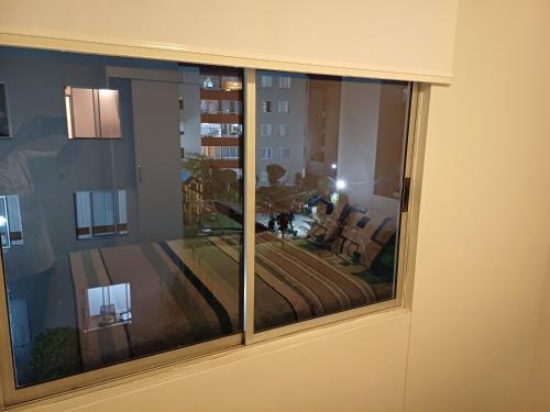a window with a view of a living room at Habitación acogedora Orué in Lima