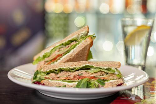 a sandwich on a white plate on a table at IQ Hotel in Kyiv