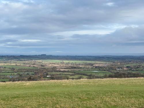 a view of a green field from a hill at Reynolds House in Faringdon