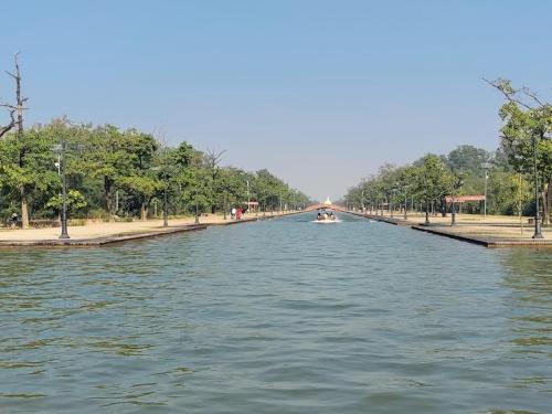 a long canal of water with a boat in it at Hotel Suramma Pvt. Ltd. in Lumbini