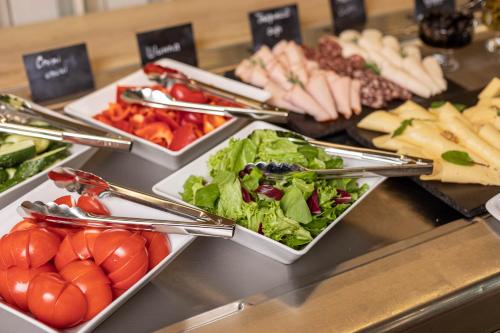 a buffet line with plates of food and appetizers at IQ Hotel in Kyiv