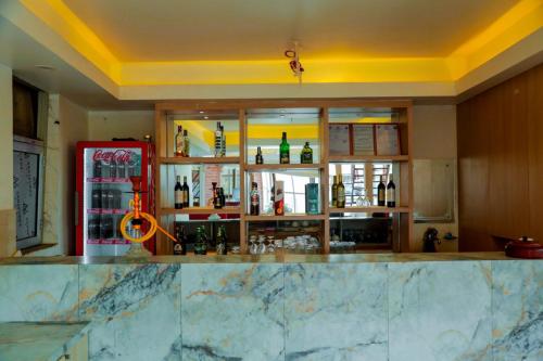 a bar in a kitchen with a red refrigerator at Hotel Kedarnath in Kathmandu