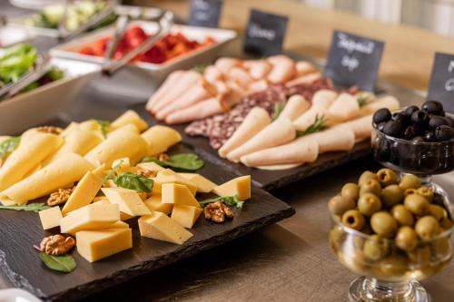 a table with two plates of cheese and other appetizers at IQ Hotel in Kyiv
