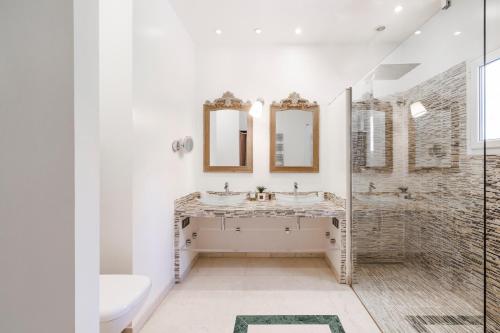 a bathroom with two sinks and a shower at Villa Athéna - Villa dexception vue montagne in Mougins