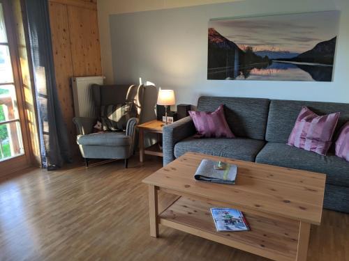 a living room with a couch and a coffee table at Niederauer Hof in Neubeuern