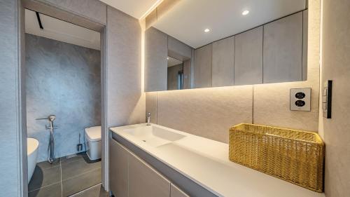 a bathroom with a sink and a toilet at Jeju Family Garden Village in Jeju