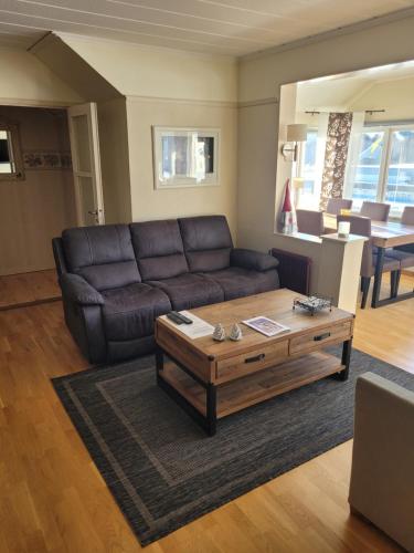 a living room with a couch and a coffee table at Wärdshuset Klarälvdalen in Sysslebäck