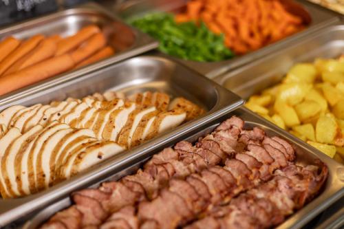 a buffet of different types of meats and other foods at IQ Hotel in Kyiv