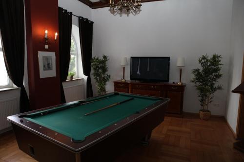 a living room with a pool table and a tv at Hotel Alt-Erfurt in Erfurt
