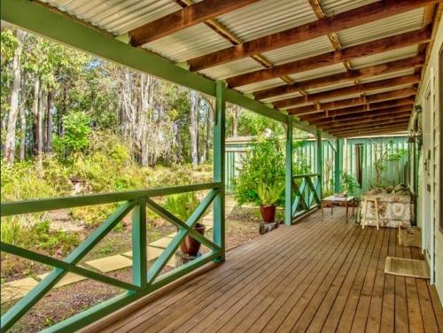 a wooden porch with awnings and a wooden ceiling at Begonia Cottage in Dwellingup