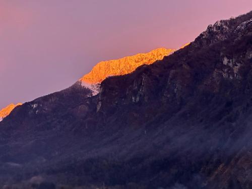 a mountain with the sun setting on it at Bed & Breakfast Casa Marinella in Lenna