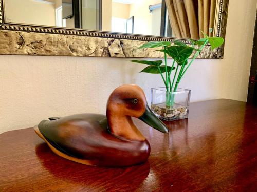 a statue of a duck sitting on a table at Westlake Waterfront Villa - Entire Villa in Hartbeespoort