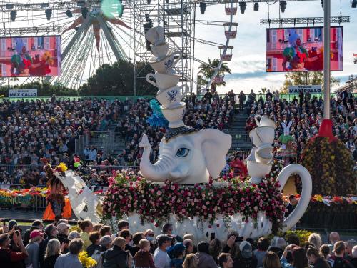 a large crowd of people watching a carnival with a float at Aparthotel AMMI Nice Lafayette in Nice
