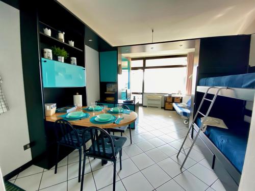 a room with a table and chairs and a bed at Residence le Dune in Lido di Camaiore