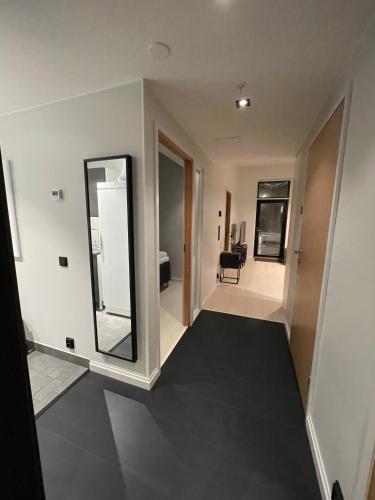 a living room with a mirror and a hallway at Levi Cranberry C1, ski-in ski-out 2 bedroom apartment in Levi center in Levi