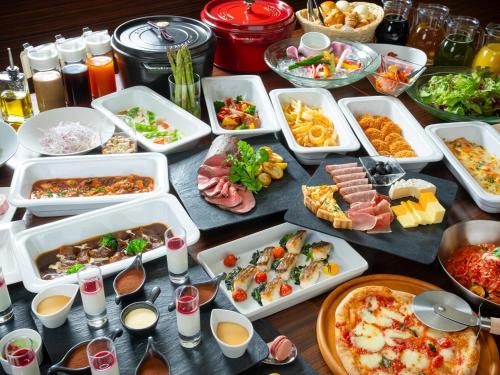 a table with many dishes of food on it at The OneFive Sendai in Sendai