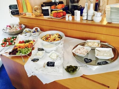 a buffet with many different types of food on a table at Dein Gutshof Hotel & Ferienwohnungen in Görlitz