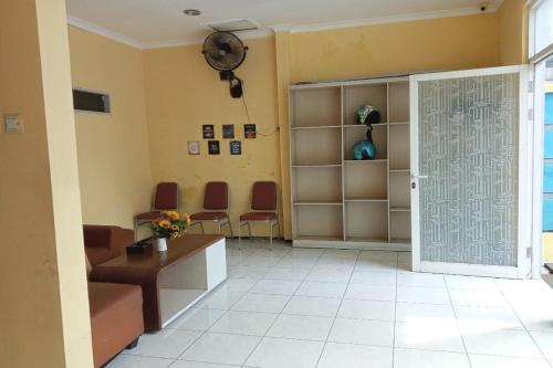 a room with a waiting room with chairs and a door at Wisma Pelita Syariah Tegal in Tegal