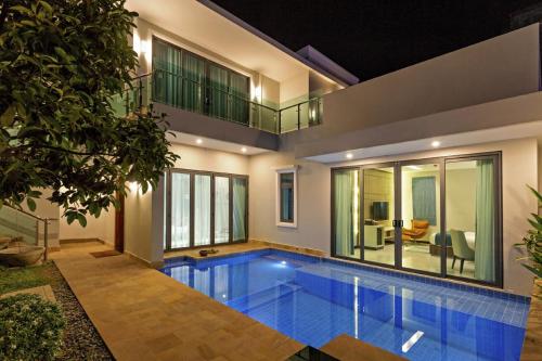 a swimming pool in the middle of a house at Castle Bayview Resort & Spa in Kampot
