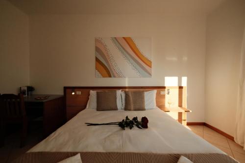 a bedroom with a bed with two pairs of shoes on it at Locanda Milano 1873 in Brunate