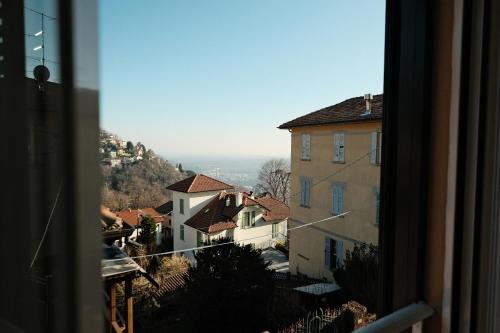 a view from a window of a town with buildings at Locanda Milano 1873 in Brunate