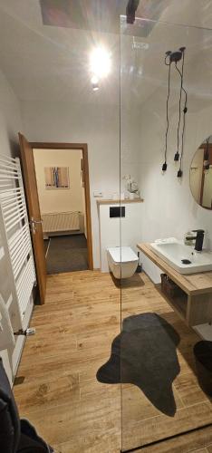 a bathroom with a toilet and a glass shower at Penzion Jelínek in Opočno