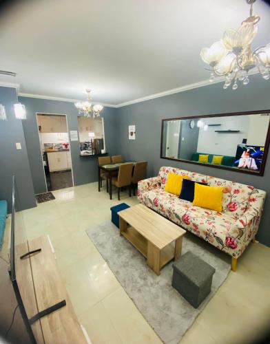 a living room with a couch and a table at Charming Duplex Apartment in Tagbilaran City