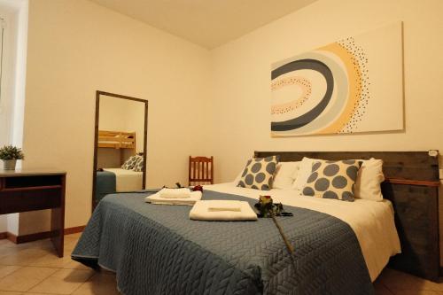 a bedroom with a large bed with a mirror at Locanda Milano 1873 in Brunate